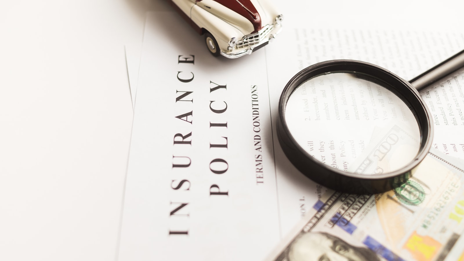 An insurance policy document under a magnifying glass
