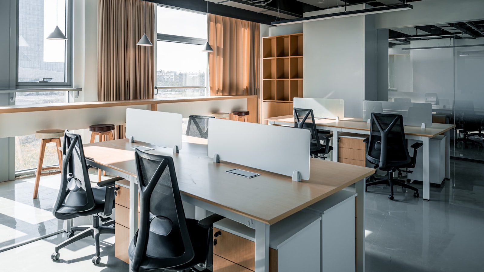 An empty office with unoccupied desks and chairs