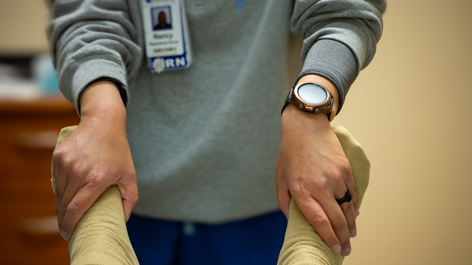 A nurse supporting a patient during physiotherapy