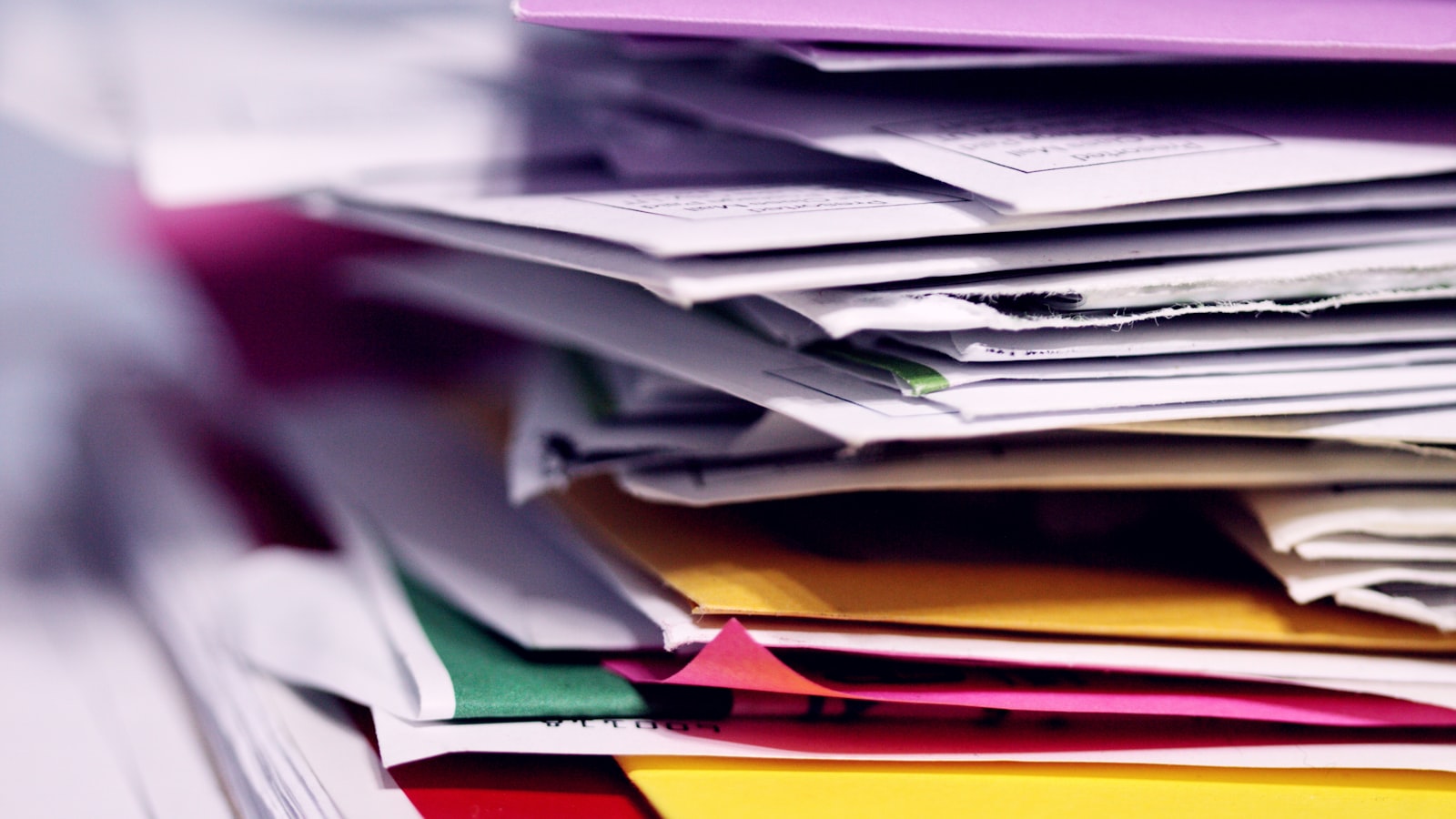 A pile of unopened mail and printed statements