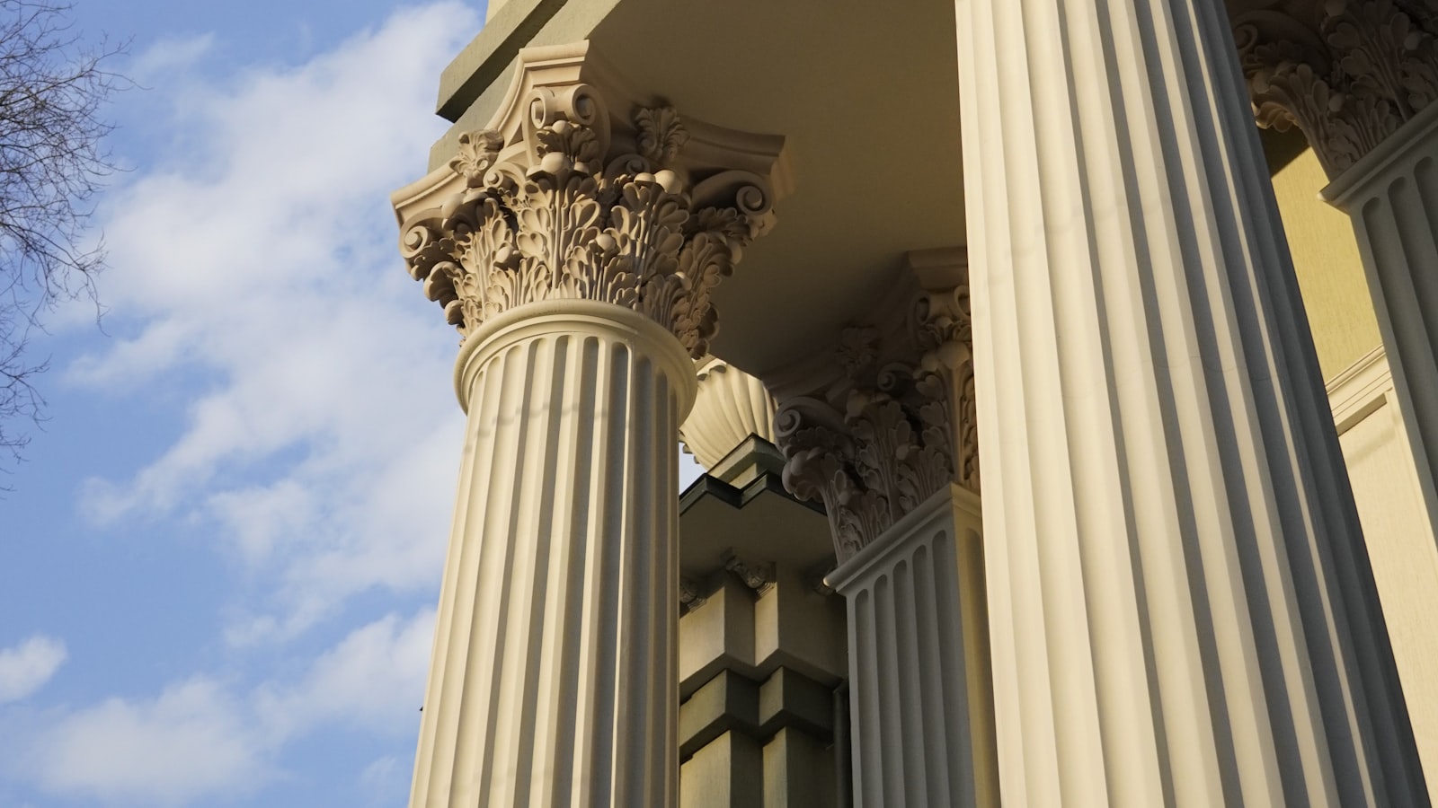 The stone columns of a courthouse against an open sky