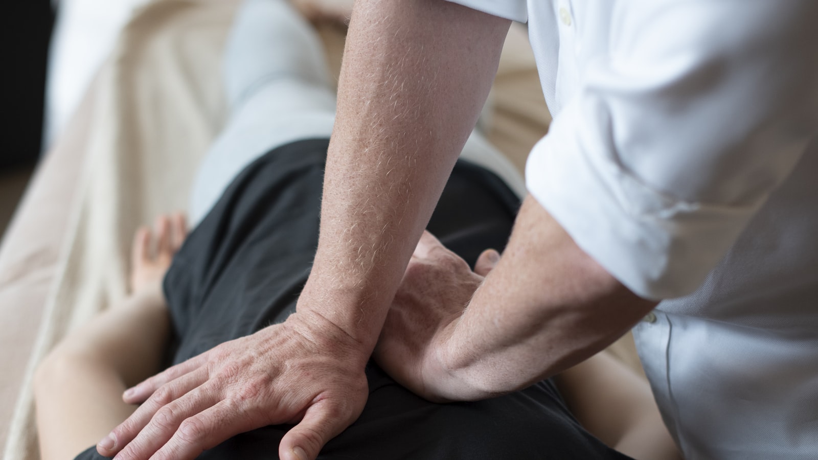 A therapist working on an injured knee