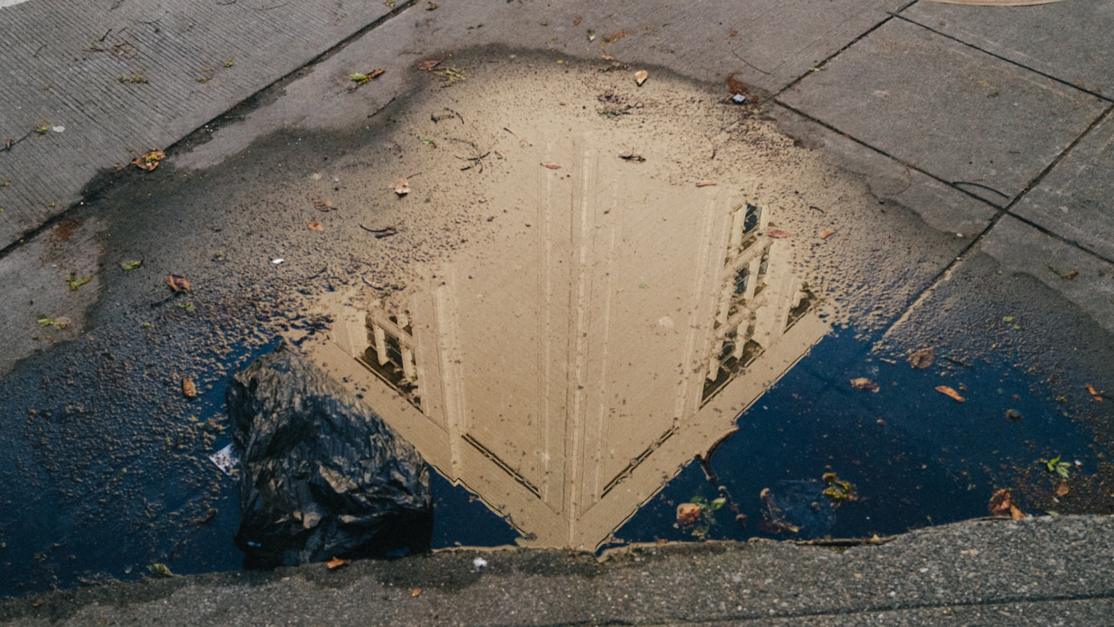A deep pothole filled with water in a road surface