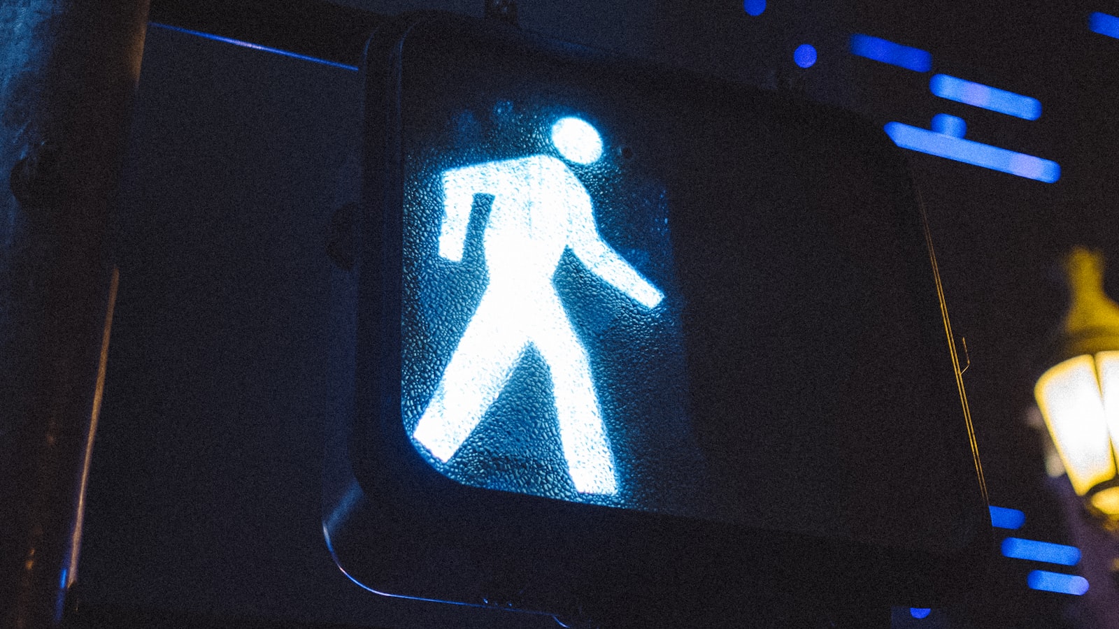 An illuminated pedestrian crossing signal at night