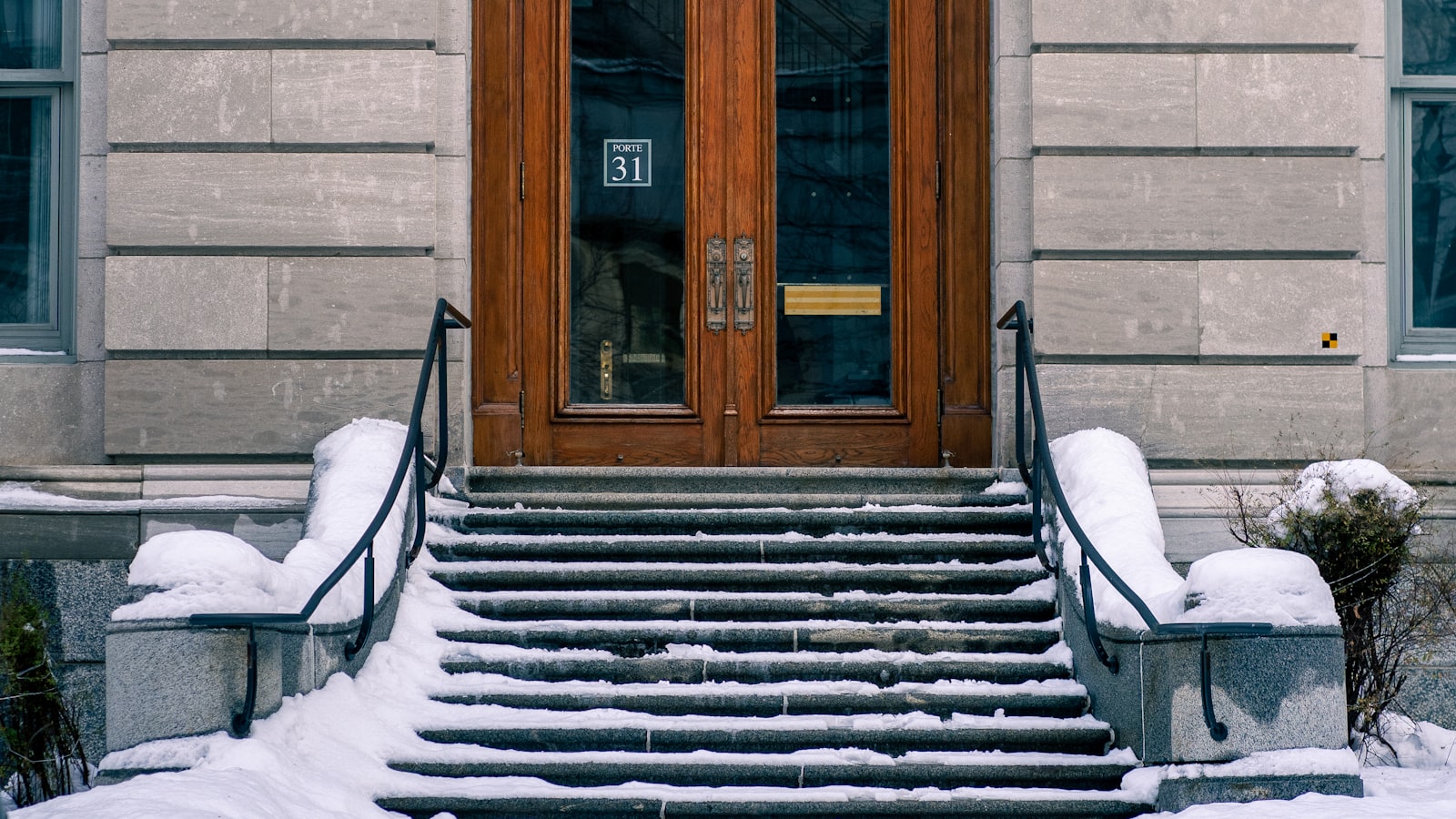 Snow and ice covering the front steps of a building